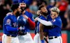 Texas Rangers' Danny Santana, second from right, is congratulated by Shin-Soo Choo after hitting a walkoff single RBI to end a baseball game against the Houston Astros, Friday, July 12, 2019, in Arlington, Texas. (AP Photo/Brandon Wade)