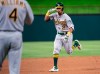 Oakland Athletics' Khris Davis (2) salutes third base coach Matt Williams (4) as he nears third on a solo home run off Texas Rangers relief pitcher Chris Martin during the eighth inning of a baseball game Friday, April 12, 2019, in Arlington, Texas. Oakland won 8-6. (AP Photo/Jeffrey McWhorter)