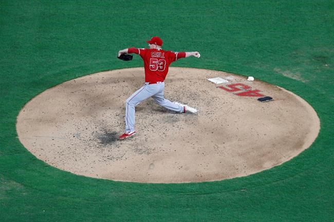 Los Angeles Angels starting pitcher Trevor Cahill (53) throws to the Texas Rangers in the fifth inning of a baseball game in Arlington, Texas, Tuesday, July 2, 2019. The number 45 on the backside of the mound honors Tyler Skaggs who passed away on Monday in Southlake, Texas. (AP Photo/Tony Gutierrez)
