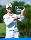 Sung Hyun Park holds up the trophy after winning the LPGA Walmart NW Arkansas Championship golf tournament, Sunday, June 30, 2019, in Rogers, Ark. (AP Photo/Michael Woods)