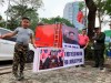 Pham Quang Dung, 8years old, wearing a hairstyle of North Korean leader Kim Jong Un, holds a placard that reads ‚ÄúFor a World of Peace‚Äù with his father Pham Quang Trung, right, near a Hanoi hotel where Kim stays on Wednesday, Feb. 27, 2019, Hanoi, Vietnam. Kim and U.S. President Donald Trump are expected to meet for their second summit Feb. 27 and 28 in Hanoi. (AP Photo/Joeal Calupitan)