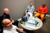 CORRECTS THE DATE TO APRIL 11, AND NOT FEB. 11 AS ORIGINALLY SENT - Artist Valentino Dixon and Max Adler of Golf Digest get ready to tell PodcastOne Sports Now hosts Jim Litke, left, and Tim Dahlberg the story of how Dixon's drawings of famous golf holes, done from his cell in Attica, sparked a legal review of his case that convinced authorities to void his wrongful conviction after 27 years in prison at Augusta National Golf Course Thursday, April 11, 2019, In Augusta, Ga. (AP Photo/Morry Gash)
