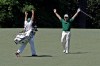 Louis Oosthuizen, of South Africa, and his caddie Wynand Stander react after Oosthuizen's double eagle two on the par 5 second hole during the fourth round of the Masters golf tournament Sunday, April 8, 2012, in Augusta, Ga. (AP Photo/Matt Slocum)