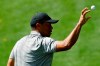Tiger Woods gets a ball from his caddie on the driving range at the Masters golf tournament Tuesday, April 9, 2019, in Augusta, Ga. (AP Photo/Matt Slocum)