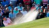 Francesco Molinari, of Italy, hits from a bunker on the 18th hole during the third round for the Masters golf tournament Saturday, April 13, 2019, in Augusta, Ga. (AP Photo/David J. Phillip)