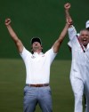 Adam Scott, of Australia, celebrates with caddie Steve Williams after making a birdie putt on the second playoff hole to win the Masters golf tournament Sunday, April 14, 2013, in Augusta, Ga. (AP Photo/David Goldman)