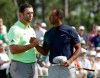 Tiger Woods shakes hands with Jon Rahm, of Spain, after their first round for the Masters golf tournament Thursday, April 11, 2019, in Augusta, Ga. (AP Photo/Marcio Jose Sanchez)