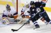 John Woods / Winnipeg Free Press
The Winnipeg Jets' Blake Wheeler (26) attempts a wraparound against the New York Islanders' Aaron Ness (55) and goaltender Evgeni Nabokov (20) during first-period play at the MTS Centre on Tuesday.