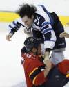 Lynne Sladky / The Associated Press
The Jets' Chris Thorburn (22) and the Panthers' Krys Barch fight in the second period on Friday in Sunrise, Fla.