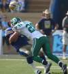 Joe Bryksa / Winnipeg Free Press
Blue Bombers quarterback Buck Pierce's helmet flies off as he gets sacked by Saskatchewan Roughrider Craig Butler in the first quarter of the Banjo Bowl at Canad Inns Stadium Sunday.