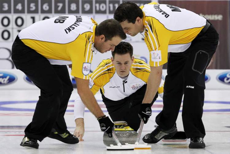 Jonathan Hayward / The Canadian Press
Manitoba skip Rob Fowler (centre) watches his shot as lead Derek Samagalski (left) and second Richard Daneault sweep during a morning draw against Saskatchewan at the Tim Hortons Brier in Saskatoon on Thursday.