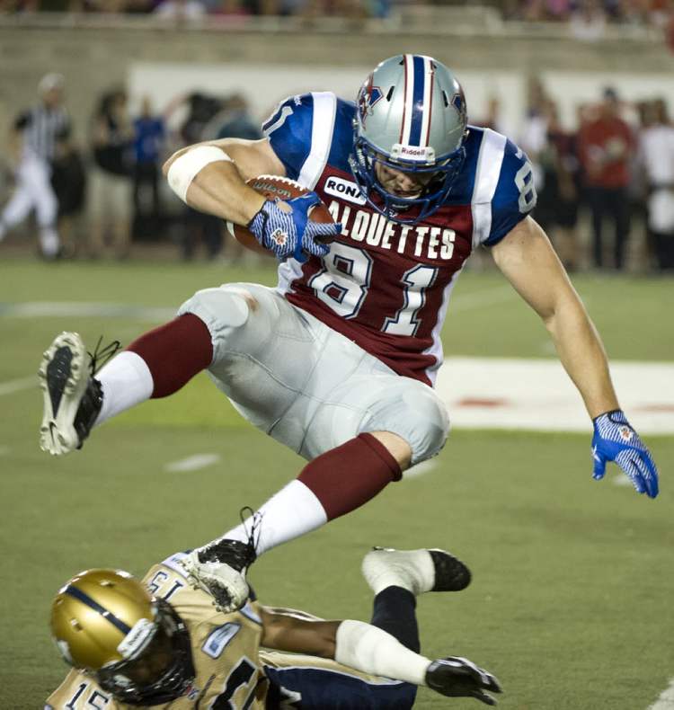 Paul Chiasson / The Canadian Press
Montreal Alouettes fullback Patrick Lavoie leaps to avoid Winnipeg Blue Bombers cornerback Demond Washington during fourth quarter CFL football action on Friday in Montreal.