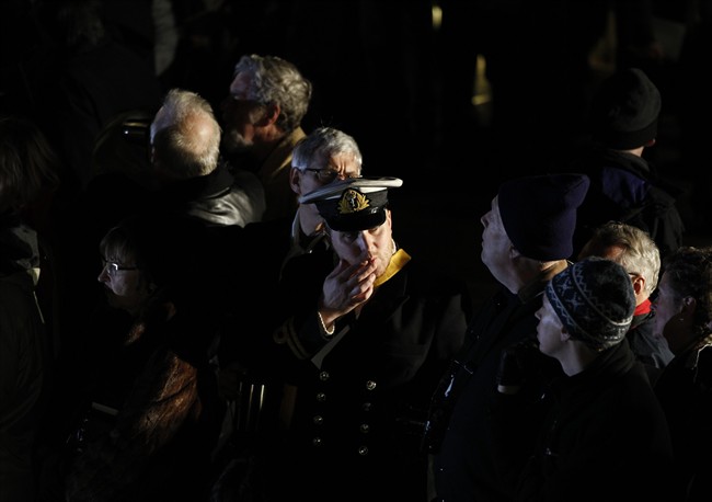Passengers participate in a memorial service, marking the 100th year anniversary of the Titanic disaster, aboard the MS Balmoral Titanic memorial cruise ship, at the wreck site in the North Atlantic Ocean, early Sunday, April 15, 2012. Cruise ship passengers and crew said prayers Sunday at the spot in the North Atlantic where the Titanic sank 100 years ago with the loss of more than 1,500 lives. (AP Photo/Lefteris Pitarakis)