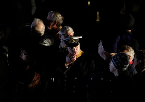 Passengers participate in a memorial service, marking the 100th year anniversary of the Titanic disaster, aboard the MS Balmoral Titanic memorial cruise ship, at the wreck site in the North Atlantic Ocean, early Sunday, April 15, 2012. Cruise ship passengers and crew said prayers Sunday at the spot in the North Atlantic where the Titanic sank 100 years ago with the loss of more than 1,500 lives. (AP Photo/Lefteris Pitarakis)