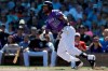 Colorado Rockies' Ian Desmond hits an RBI-single against the San Francisco Giants during the first inning of a spring baseball game in Scottsdale, Ariz., Sunday, March 3, 2019. (AP Photo/Chris Carlson)