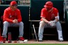 Los Angeles Angels manager Brad Ausmus, left, talks with Mike Trout during the fourth inning of a spring baseball game against the Oakland Athletics in Mesa, Ariz., Tuesday, Feb. 26, 2019. (AP Photo/Chris Carlson)
