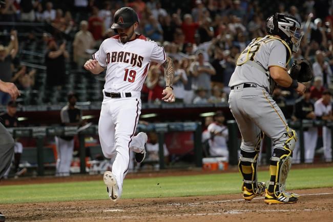 Arizona Diamondbacks' Blake Swihart, left, scores past Pittsburgh Pirates catcher Francisco Cervelli on inside the park home run during the eighth inning of a baseball game in Phoenix, Wednesday, May 15, 2019. (AP Photo/Matt York)