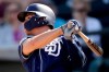 San Diego Padres' Luis Urias watches his two-run home run during the third inning of a spring training baseball game against the Kansas City Royals Thursday, Feb. 28, 2019, in Surprise, Ariz. (AP Photo/Charlie Riedel)