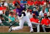 Colorado Rockies' Trevor Story doubles against the Los Angeles Angels in the second inning of a spring training baseball game Wednesday, March 6, 2019, in Scottsdale, Ariz. (AP Photo/Elaine Thompson)