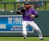 Colorado Rockies right fielder Charlie Blackmon chases a ball that fell in for a single from Oakland Athletics' Marcus Semien in the fourth inning of a spring training baseball game Monday, March 11, 2019, in Scottsdale, Ariz. (AP Photo/Elaine Thompson)
