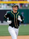 Oakland Athletics' Mike Hundley rounds the bases on his solo home run against the Chicago Cubs in the third inning of a spring training baseball game, Wednesday, March 13, 2019, in Mesa, Ariz. (AP Photo/Elaine Thompson)