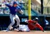 Chicago Cubs shortstop Javier Baez, left, throws to first base after forcing out Arizona Diamondbacks' Ketel Marte at second base in the first inning of a spring training baseball game Saturday, March 16, 2019, in Scottsdale, Ariz. Baez completed the double play on Diamondbacks' Carson Kelly at first. (AP Photo/Elaine Thompson)