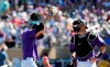 Colorado Rockies starting pitcher Kyle Freeland, left, wipes his face as he talks with catcher Chris Iannetta in the fifth inning of a spring training baseball game against the Cincinnati Reds, Monday, March 18, 2019, in Scottsdale, Ariz. (AP Photo/Elaine Thompson)