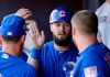 Chicago Cubs' David Bote is congratulated after scoring against the San Diego Padres in the fourth inning of a spring training baseball game Sunday, March 24, 2019, in Peoria, Ariz. (AP Photo/Elaine Thompson)