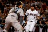 Arizona Diamondbacks' Ketel Marte (4) scores on a base hit by Christian Walker as Miami Marlins catcher Jorge Alfaro waits for the throw during the third inning of a baseball game Tuesday, Sept. 17, 2019, in Phoenix. (AP Photo/Matt York)