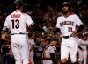 Arizona Diamondbacks' Adam Jones (10) greets teammate Nick Ahmed (13) after scoring on a base hit by Jake Lamb during the third inning of a baseball game against the Baltimore Orioles, Monday, July 22, 2019, in Phoenix. (AP Photo/Matt York)