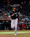 Colorado Rockies' Ian Desmond (20) scores on a base hit by Chris Iannetta during the 10th inning of the team's baseball game against the Arizona Diamondbacks, Thursday, June 20, 2019, in Phoenix. The Rockies won 6-4. (AP Photo/Matt York)