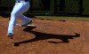 Kansas City Royals pitcher Brad Keller casts a shadow on the mound in the bullpen as he warms up prior to a spring training baseball game against the Cleveland Indians, Wednesday, March 13, 2019, in Surprise, Ariz. (AP Photo/Ross D. Franklin)