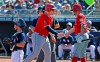 Los Angeles Angels' Justin Bour, middle, celebrates his run scored against the San Diego Padres with Peter Bourjos, right, as Padres catcher Austin Hedges, left, waits at home plate during the first inning of a spring training baseball game Sunday, March 17, 2019, in Peoria, Ariz. (AP Photo/Ross D. Franklin)