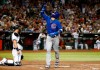 Chicago Cubs' Javier Baez, right, gestures skyward as he crosses the plate after hitting a home run against the Arizona Diamondbacks during the fourth inning of a baseball game, Friday, April 26, 2019, in Phoenix. (AP Photo/Ralph Freso)
