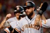 San Francisco Giants' Brandon Belt celebrates with teammates after hitting a grand slam against the Arizona Diamondbacks in the second inning during a baseball game, Saturday, Aug. 17, 2019, in Phoenix. (AP Photo/Rick Scuteri)