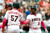 Arizona Diamondbacks' Adam Jones (10) celebrates with Jon Duplantier after hitting a two run homerun against the Atlanta Braves in the fourth inning during a baseball game, Sunday, May 12, 2019, in Phoenix. (AP Photo/Rick Scuteri)