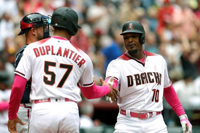 Arizona Diamondbacks' Adam Jones (10) celebrates with Jon Duplantier after hitting a two run homerun against the Atlanta Braves in the fourth inning during a baseball game, Sunday, May 12, 2019, in Phoenix. (AP Photo/Rick Scuteri)