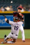 Arizona Diamondbacks shortstop Nick Ahmed turns the double play while avoiding Colorado Rockies' Charlie Blackmon (19) on a ball hit by Ryan McMahon in the seventh inning during a baseball game, Wednesday, Aug. 21, 2019, in Phoenix. (AP Photo/Rick Scuteri)