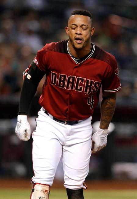 Arizona Diamondbacks' Ketel Marte reacts after getting hit by a foul ball in the seventh inning of a baseball game against the Washington Nationals, Sunday, Aug. 4, 2019, in Phoenix. (AP Photo/Rick Scuteri)