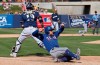 Texas Rangers' Nolan Fontana scores behind Milwaukee Brewers catcher Yasmani Grandal on a sacrifice fly by Willie Calhoun in the sixth inning of a spring training baseball game Tuesday, March 19, 2019, in Phoenix (AP Photo/Sue Ogrocki)