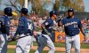 Milwaukee Brewers Orlando Arcia, second from right, is congratulated by teammate Jesus Aguilar (24) after a solo home run in the fourth inning of a spring training baseball game against the Chicago Cubs Sunday, March 10, 2019, in Phoenix. At left are Cory Spangenberg (5) and Ben Gamel (16). (AP Photo/Sue Ogrocki)