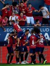 Osasuna players celebrate after scoring against FC Barcelona during the Spanish La Liga soccer match between FC Barcelona and Osasuna, at El Sadar stadium, in Pamplona, northern Spain, Saturday, Aug. 31, 2019. (AP Photo/Alvaro Barrientos)