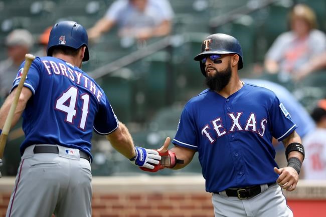 Texas Rangers' Rougned Odor, right, reacts with Logan Forsythe (41) after Odor scored on a single by Nick Solak, not seen, during the first inning of a baseball game against the Baltimore Orioles, Sunday, Sept. 8, 2019, in Baltimore. (AP Photo/Nick Wass)