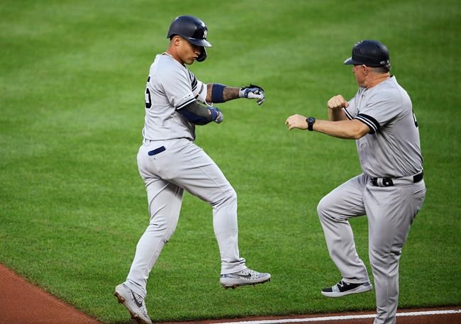 New York Yankees' Gleyber Torres, left, celebrates his home run with third base coach Phil Nevin during the third inning of the team's baseball game against the Baltimore Orioles, Wednesday, May 22, 2019, in Baltimore. (AP Photo/Nick Wass)