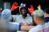 Houston Astros' Yordan Alvarez, center, is greeted in the dugout after hitting a solo home run off Baltimore Orioles starting pitcher Aaron Brooks during the first inning of a baseball game Saturday, Aug. 10, 2019, in Baltimore. (AP Photo/Julio Cortez)