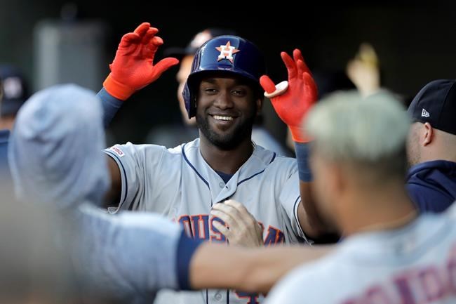 Houston Astros' Yordan Alvarez, center, is greeted in the dugout after hitting a solo home run off Baltimore Orioles starting pitcher Aaron Brooks during the first inning of a baseball game Saturday, Aug. 10, 2019, in Baltimore. (AP Photo/Julio Cortez)