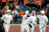 Tampa Bay Rays' Austin Meadows, center left, celebrates with Matt Duffy, right, as Mike Zunino, left, and Tommy Pham, back, look on after Meadows scored them all on a grand slam off Baltimore Orioles starting pitcher Ty Blach during the second inning of a baseball game, Friday, Aug. 23, 2019, in Baltimore. (AP Photo/Julio Cortez)