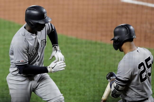 New York Yankees' Didi Gregorius, left, celebrates his solo home run off Baltimore Orioles starting pitcher Asher Wojciechowski with Gleyber Torres during the third inning of a baseball game Tuesday, Aug. 6, 2019, in Baltimore. (AP Photo/Julio Cortez)