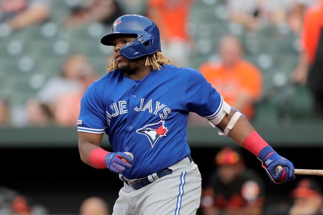 Toronto Blue Jays' Vladimir Guerrero Jr. watches his RBI single off Baltimore Orioles starting pitcher Aaron Brooks during the first inning of a baseball game Friday, Aug. 2, 2019, in Baltimore. (AP Photo/Julio Cortez)