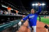 Los Angeles Dodgers manager Dave Roberts gestures to the crowd after the team's baseball game against the Baltimore Orioles, Tuesday, Sept. 10, 2019, in Baltimore. The Dodgers won 7-3, clinching their seventh consecutive NL West title. (AP Photo/Nick Wass)